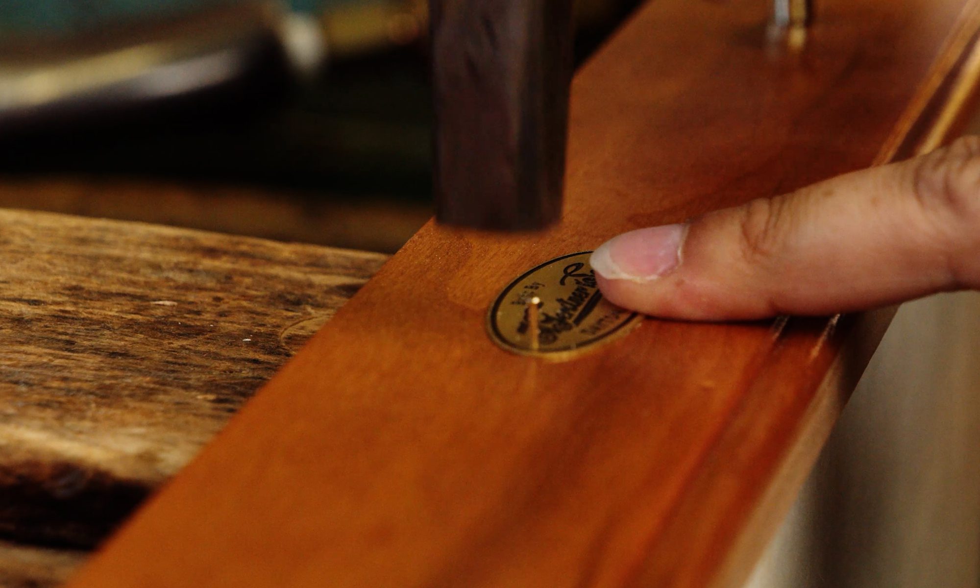 Installing Gerstner badge during final inspection of wood tool chest
