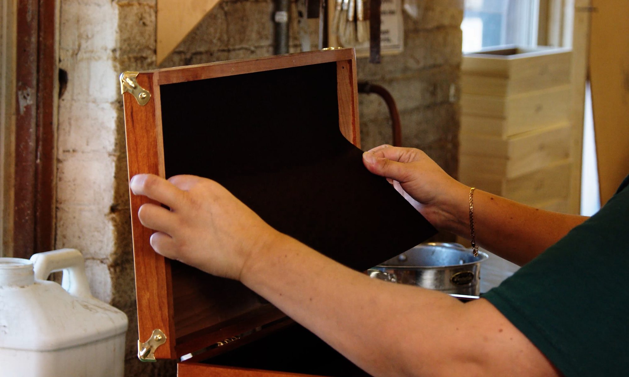 Hand installing interior lining in a Gerstner wood tool chest